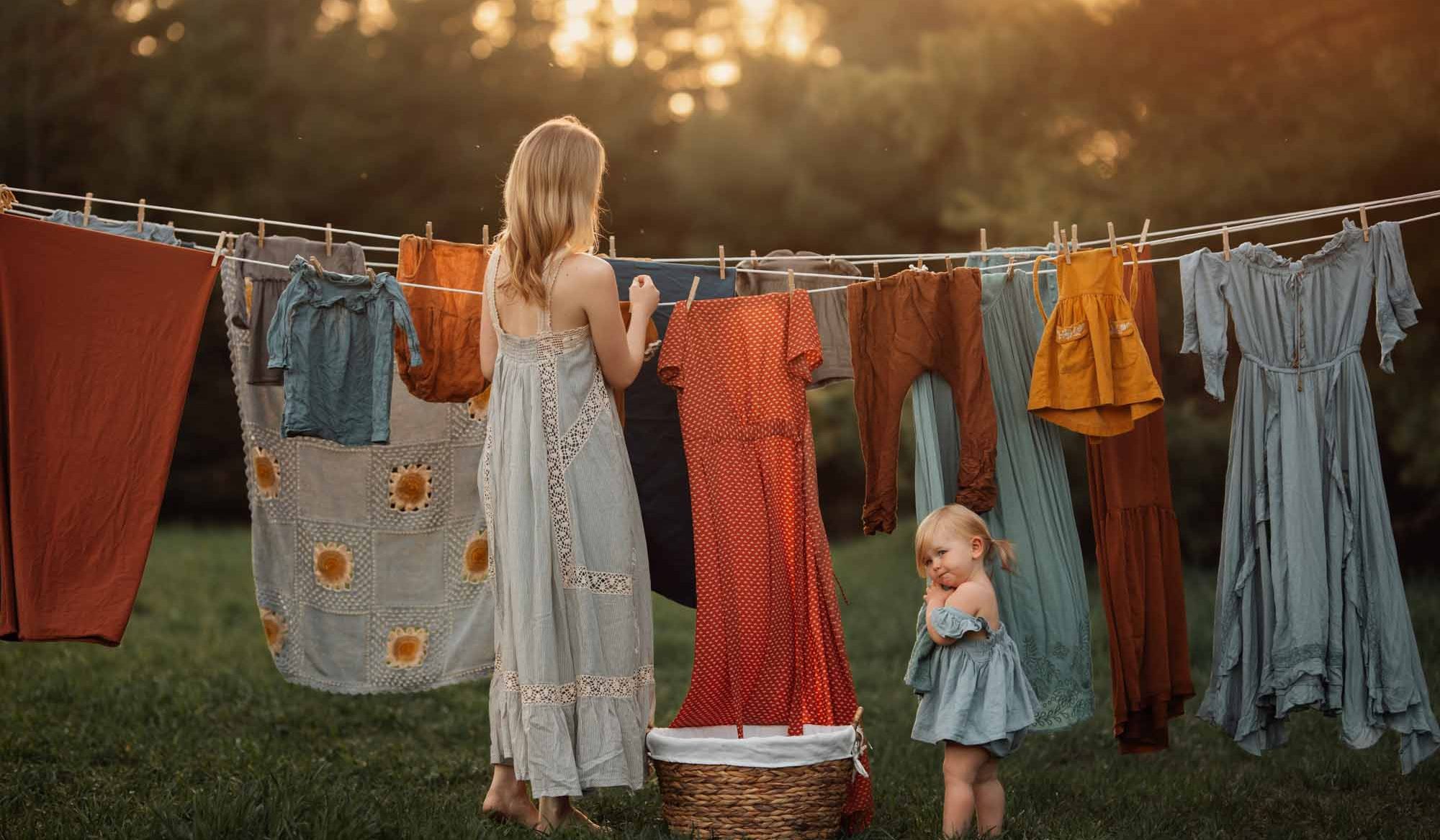 Marquette, MI 5/23/2020 - Meg Loeks and her daughter along the clothesline at their home. Canon 5D Mark IV and 105mm 1.4 DG HSM. 1/800, F1.8, ISO 160